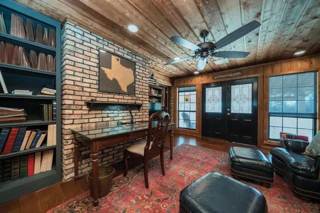 a living room with furniture a piano and a bookshelf