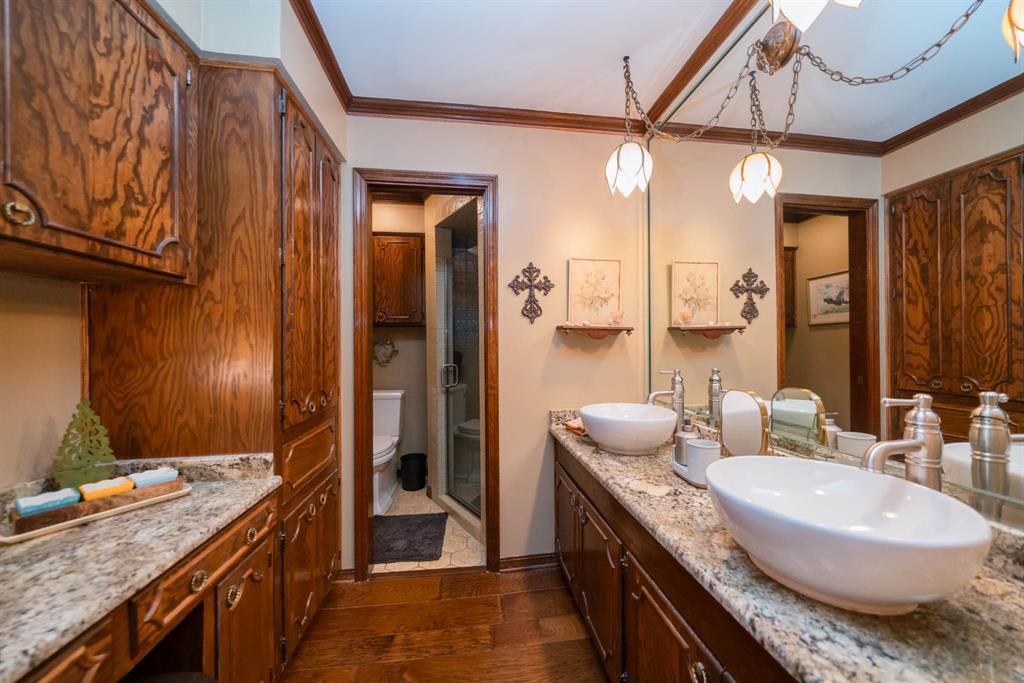 3843 Farm To Market 2199 Marshall, TX 75672 - Photo 19 of 40 a bathroom with a granite countertop sink a mirror and a shower