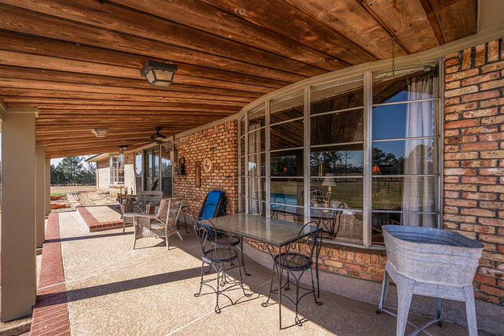 3843 Farm To Market 2199 Marshall, TX 75672 - Photo 26 of 40 a view of a patio with table and chairs and potted plants