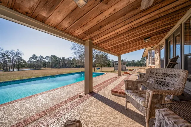 a view of a house with backyard porch and sitting area