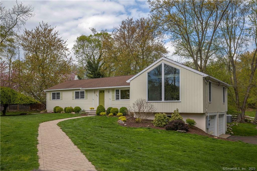 a front view of house with yard and green space