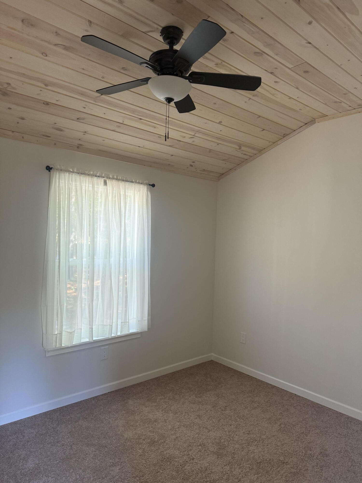 749 Brookside Drive DeFuniak Springs, FL 32433 - Photo 11 of 18 an empty room with a ceiling fan and window