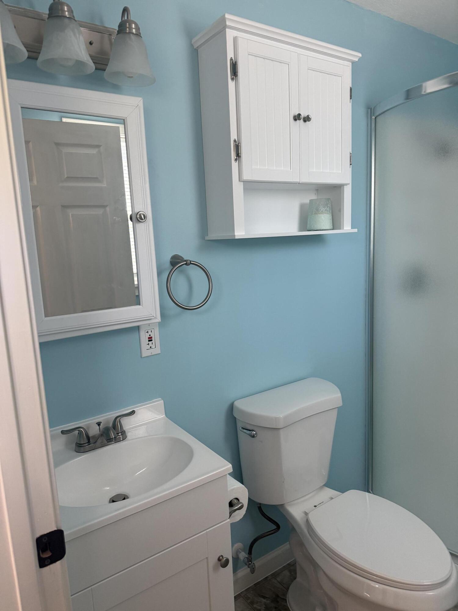 749 Brookside Drive DeFuniak Springs, FL 32433 - Photo 16 of 18 a white toilet sitting next to a bathroom sink