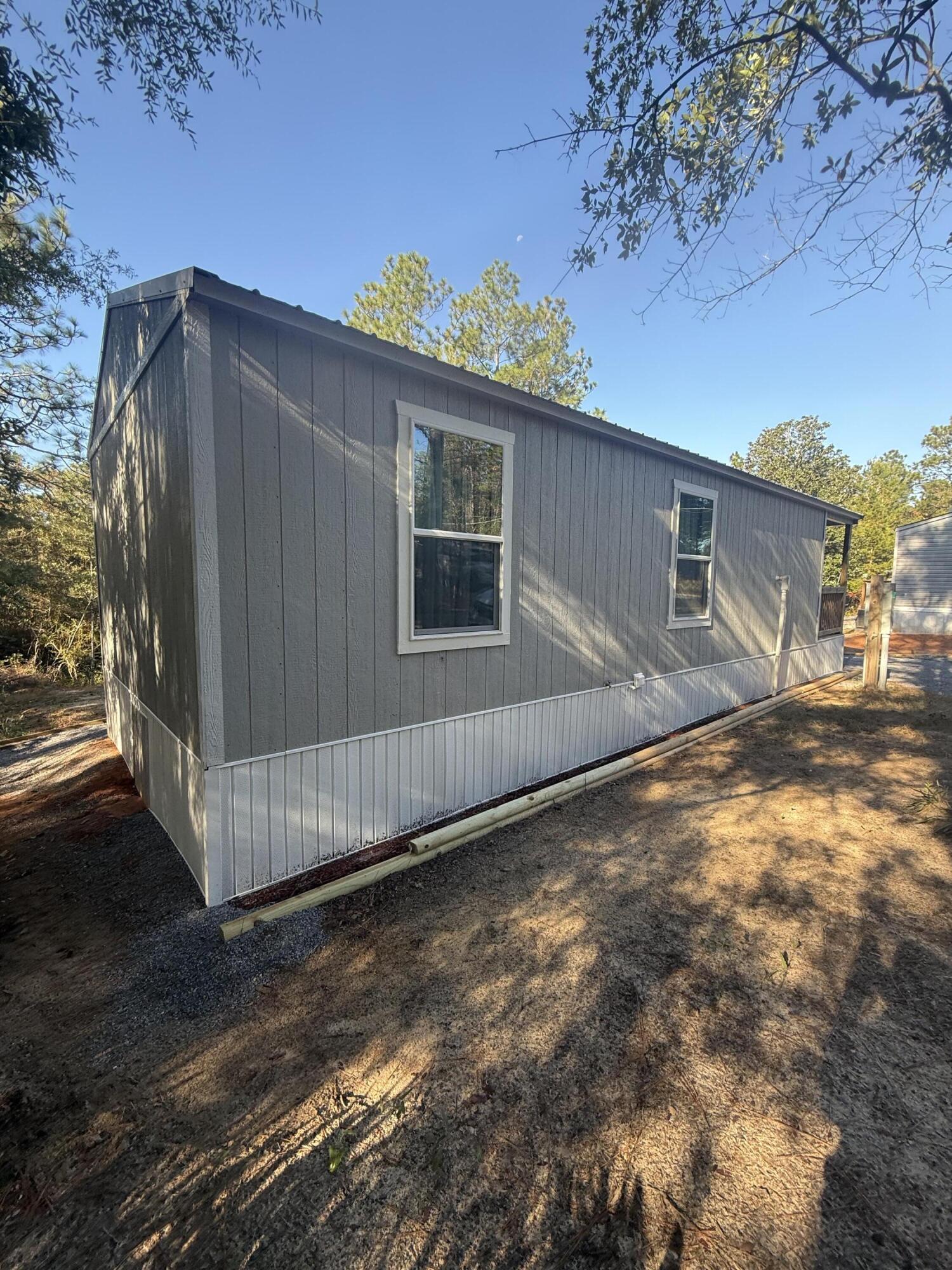 749 Brookside Drive DeFuniak Springs, FL 32433 - Photo 4 of 18 a view of a house with a backyard