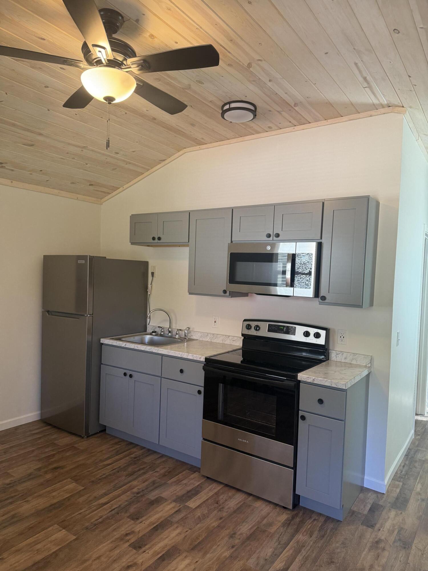 749 Brookside Drive DeFuniak Springs, FL 32433 - Photo 5 of 18 a kitchen with stainless steel appliances a sink and a stove