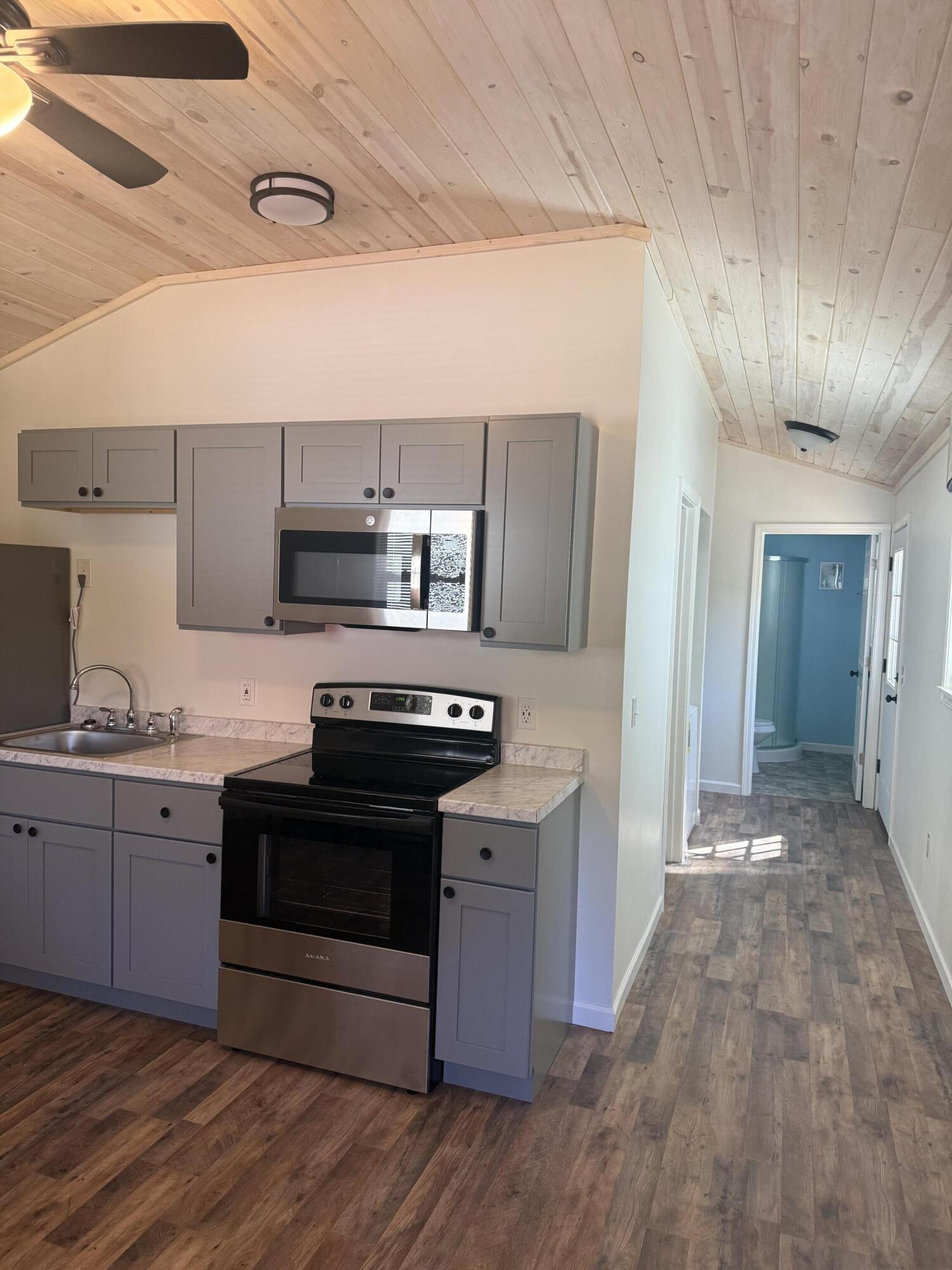 749 Brookside Drive DeFuniak Springs, FL 32433 - Photo 6 of 18 a kitchen with granite countertop a stove and a refrigerator