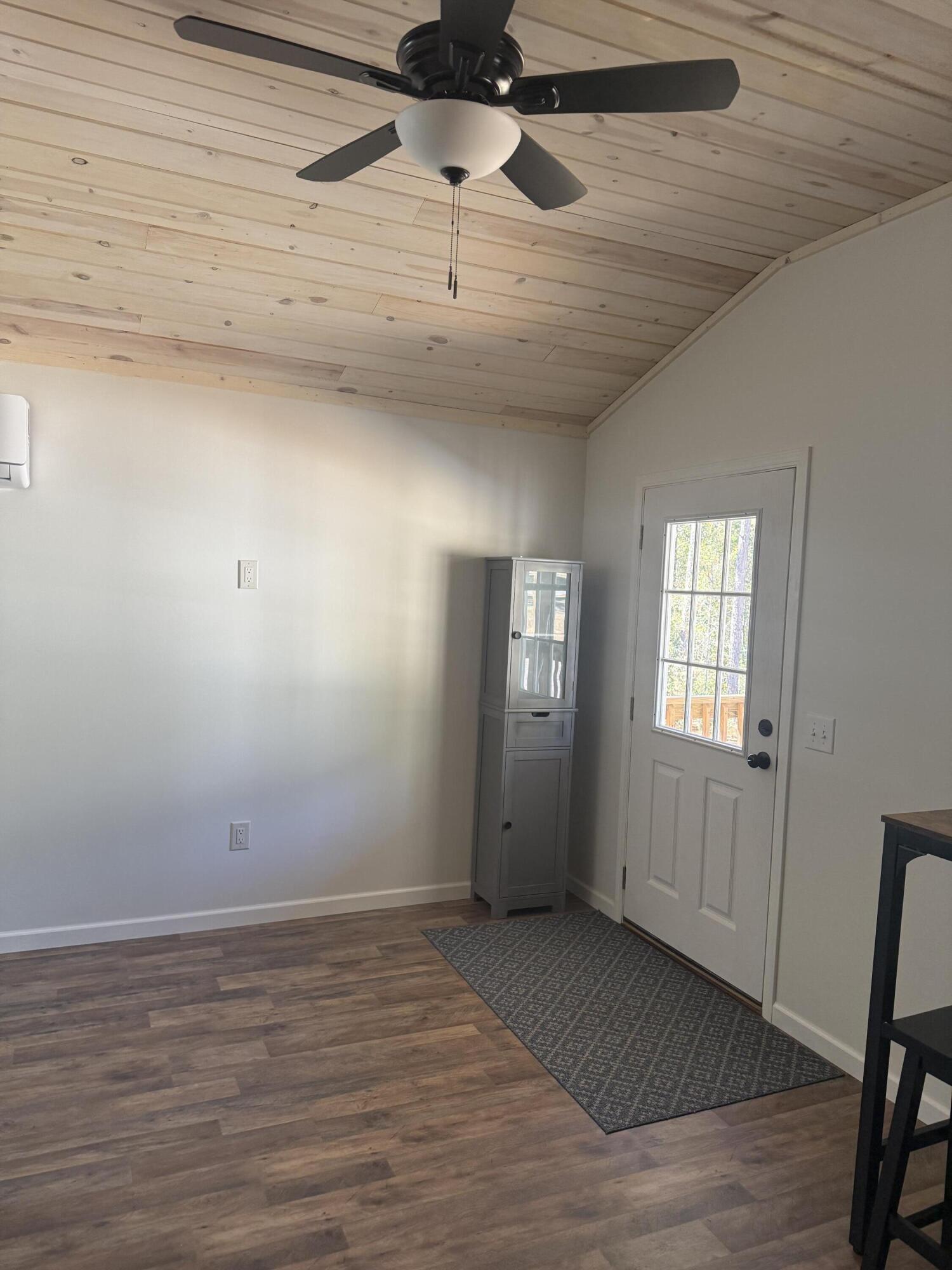 749 Brookside Drive DeFuniak Springs, FL 32433 - Photo 8 of 18 a view of a room with wooden floor and ceiling fan