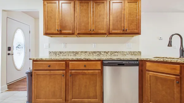 a view of a kitchen with granite countertop cabinets stainless steel appliances and a counter space