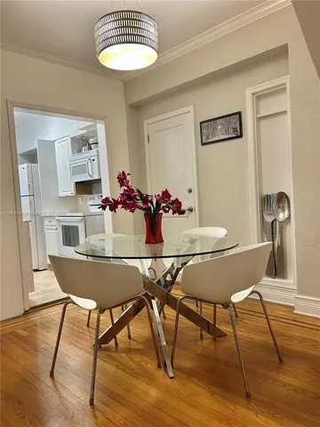 a view of a dining room with furniture and wooden floor