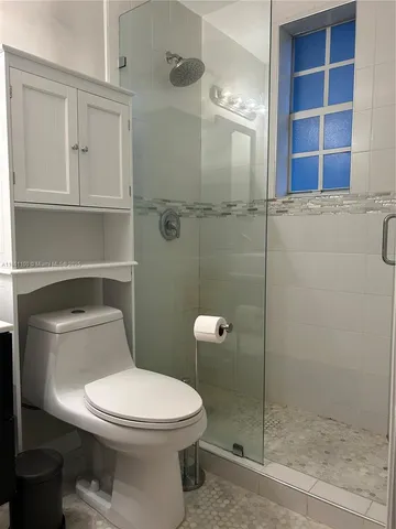 a bathroom with a toilet and a shower