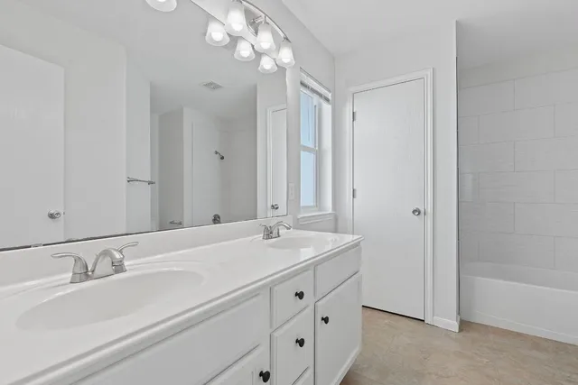 a bathroom with a sink double vanity and a mirror