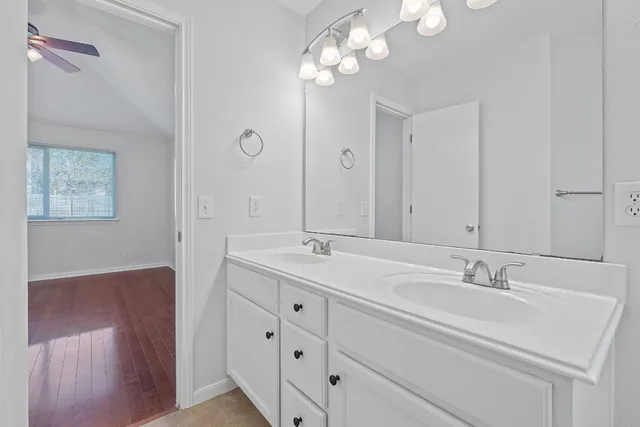 a bathroom with a double vanity sink and a mirror