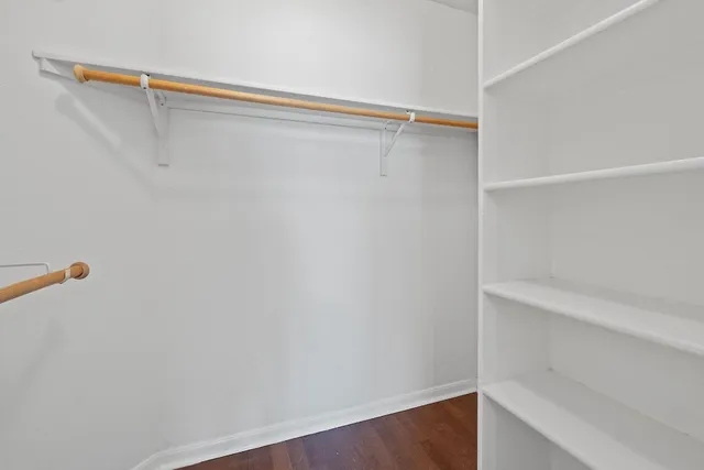 a view of walk in closet with empty racks