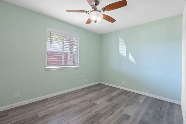 a view of a room with wooden floor and windows