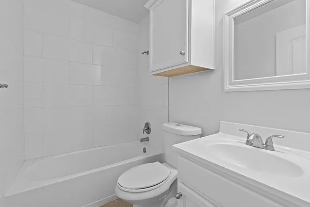 a white toilet sitting next to a bathroom sink