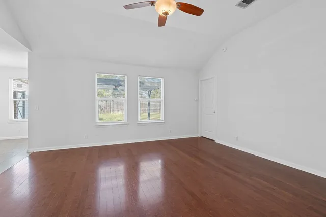 wooden floor in an empty room with a window