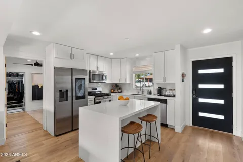 a living room with furniture and view of kitchen