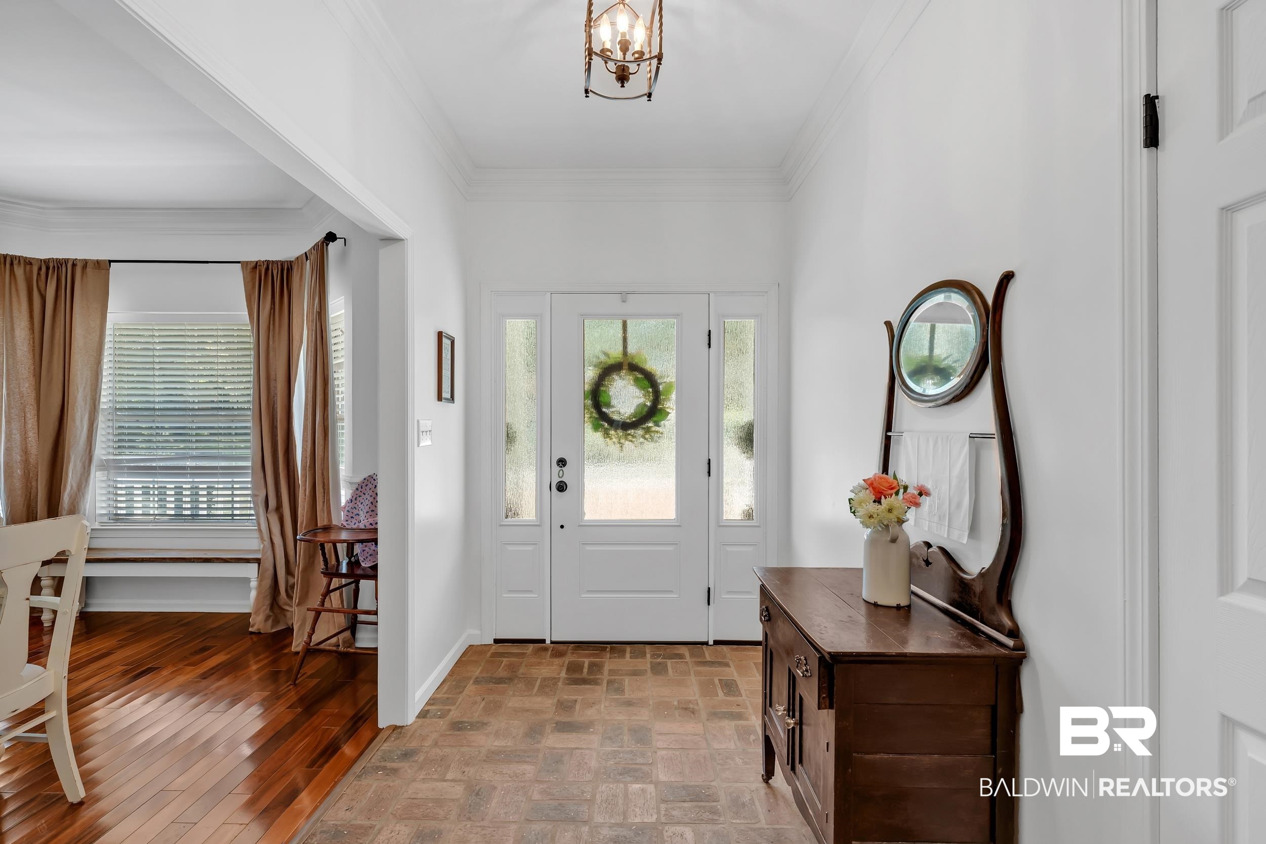 2 Navy Lane Daphne, AL 36527 - Photo 13 of 28 Entryway featuring ornamental molding, a chandelier, and brick patterned floors
