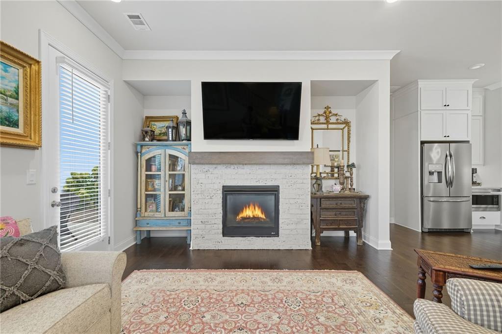514 Homestead Park Place Canton, GA 30115 - Photo 13 of 38 a living room with furniture a flat screen tv and a fireplace