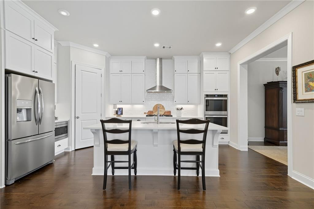 514 Homestead Park Place Canton, GA 30115 - Photo 15 of 38 a kitchen with white cabinets and stainless steel appliances