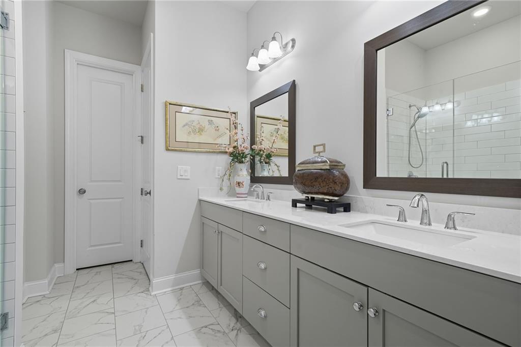 514 Homestead Park Place Canton, GA 30115 - Photo 22 of 38 a bathroom with double sink and a mirror