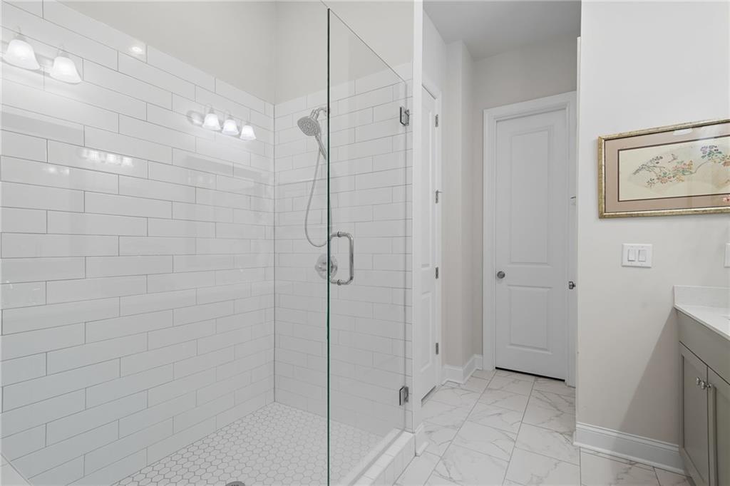 514 Homestead Park Place Canton, GA 30115 - Photo 23 of 38 a bathroom with a shower and a glass door