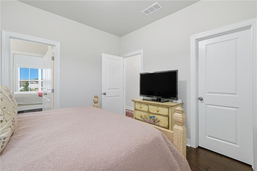 514 Homestead Park Place Canton, GA 30115 - Photo 27 of 38 a bedroom with a bed and a flat screen tv
