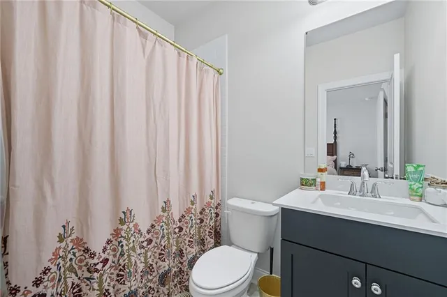 a bathroom with a toilet a sink and a mirror