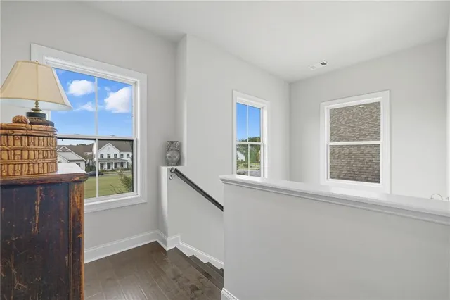 an entryway with wooden floor and cabinet