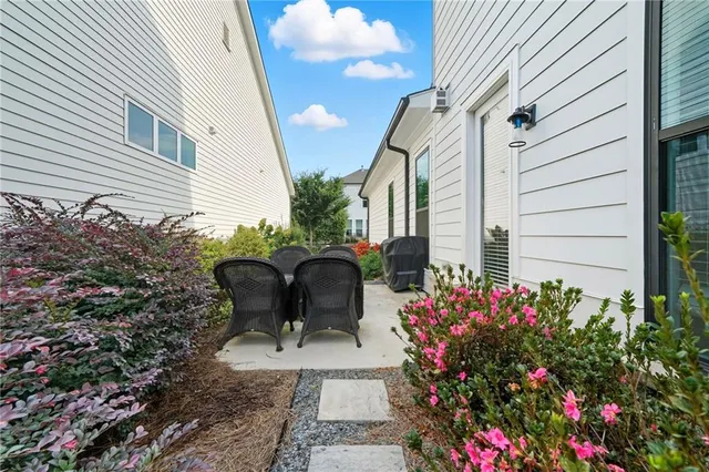 a view of a chair and table in the backyard