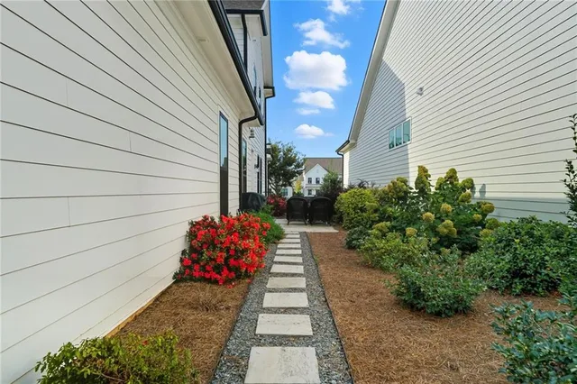 a view of a pathway besides a house