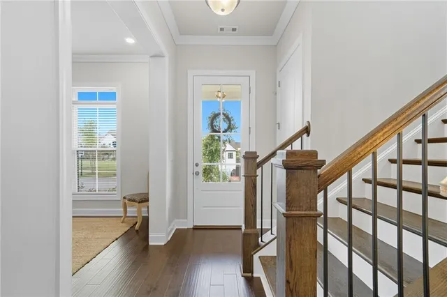 a view of entryway with wooden floor and stairs