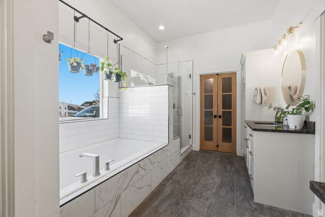 2013 South 100 West Perry, UT 84302 - Photo 25 of 49 Sleek bathroom featuring a built-in tub with marble-look paneling and subway tile surround