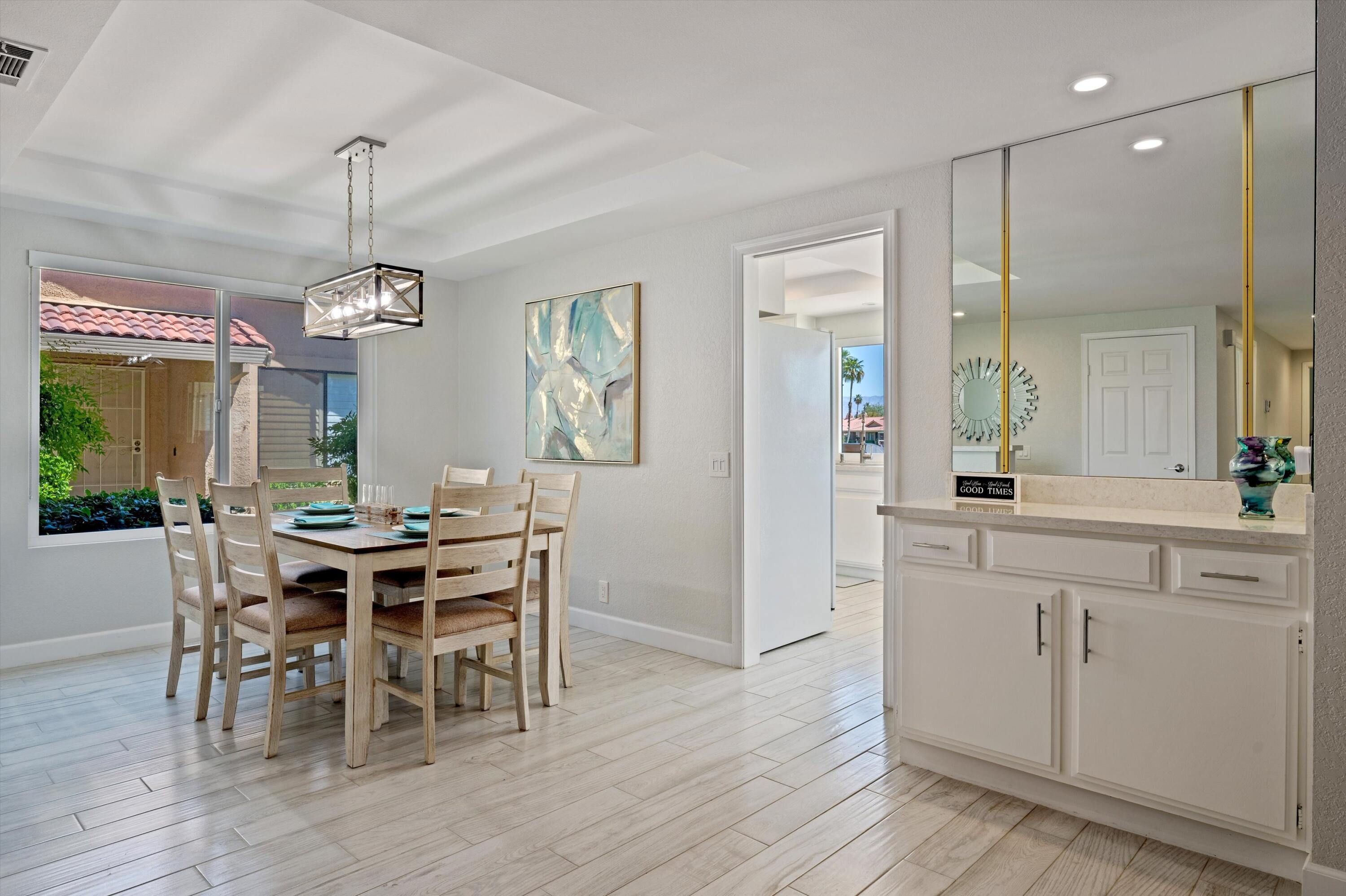 34 Maximo Way Palm Desert, CA 92260 - Photo 19 of 31 a view of a dining room with furniture window and wooden floor