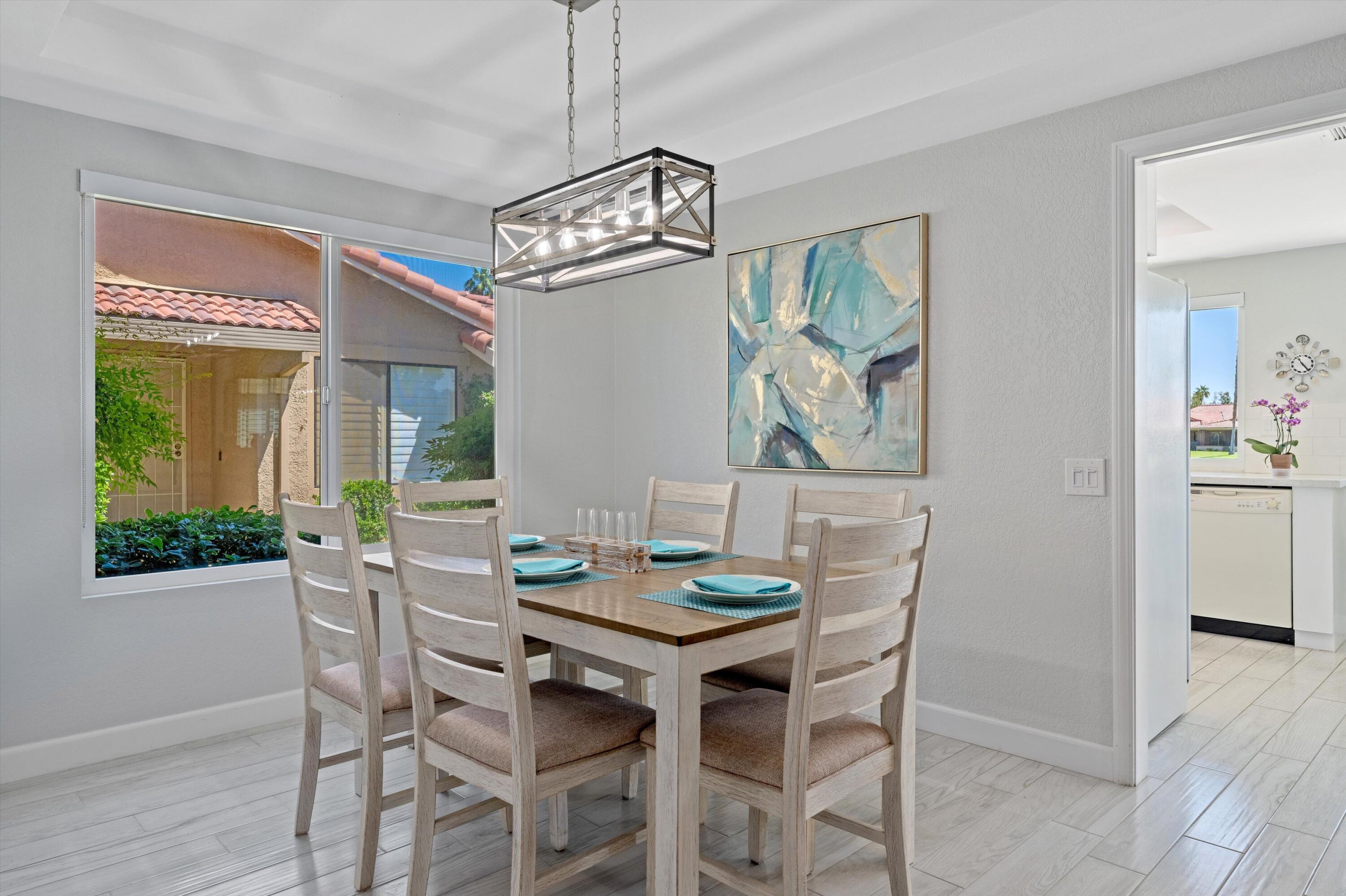 34 Maximo Way Palm Desert, CA 92260 - Photo 20 of 31 a view of a dining room with furniture window and wooden floor