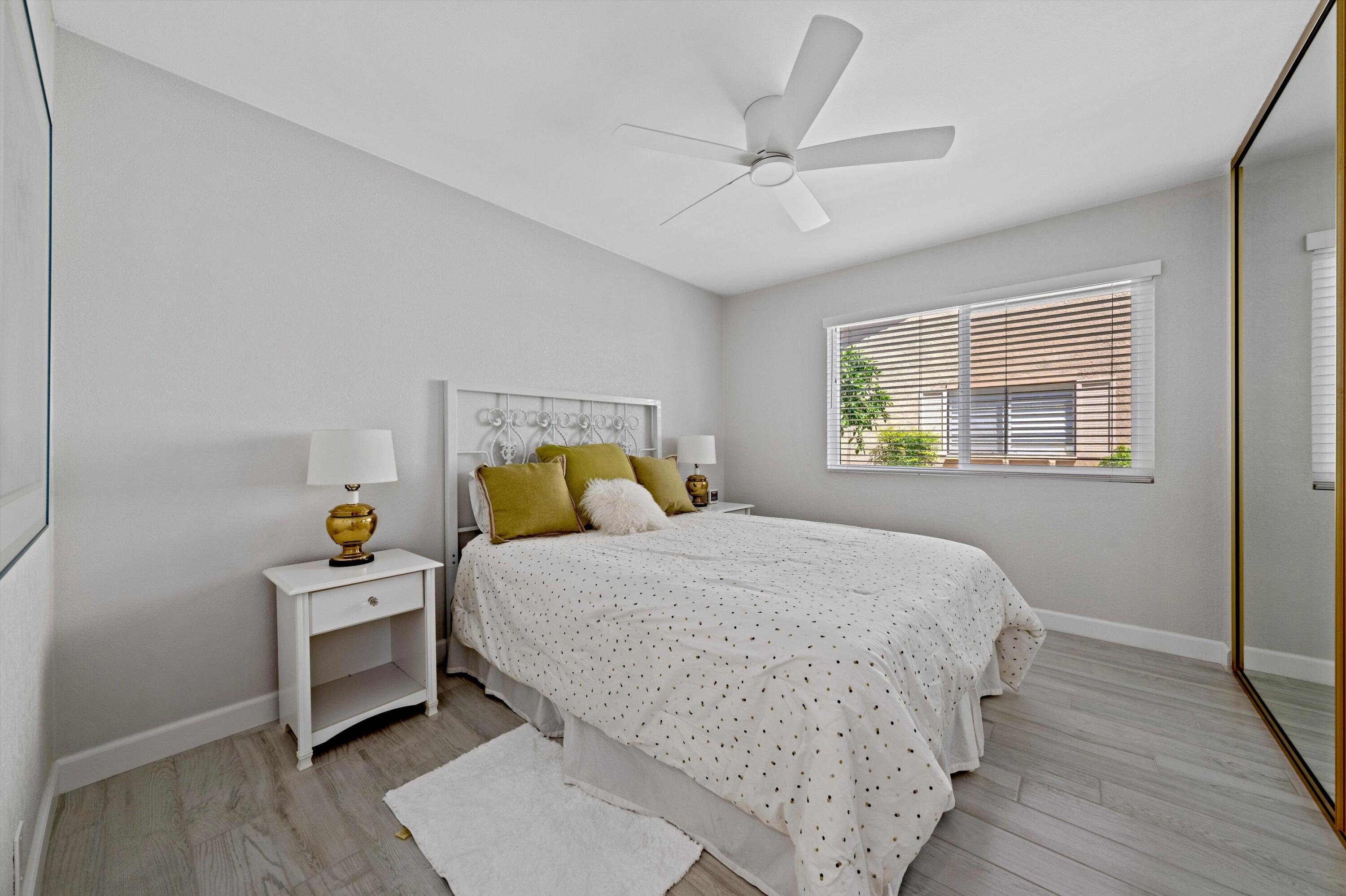 34 Maximo Way Palm Desert, CA 92260 - Photo 25 of 31 a bedroom with a bed and wooden floor