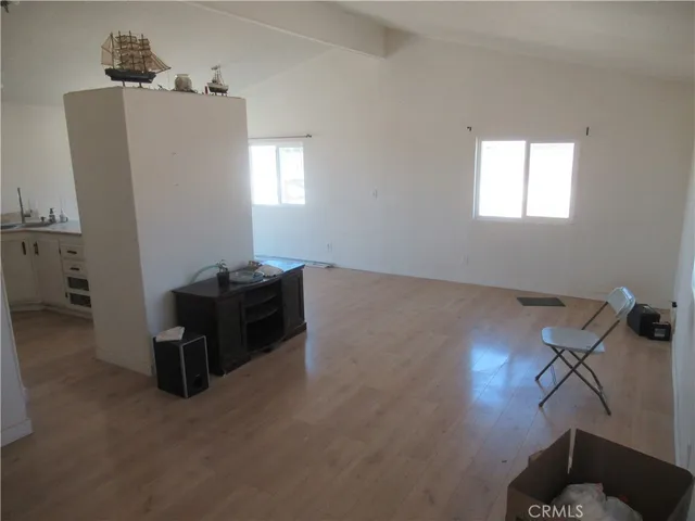a kitchen with granite countertop a sink a stove and a refrigerator