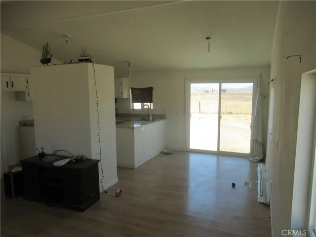 a room with a sink and a refrigerator