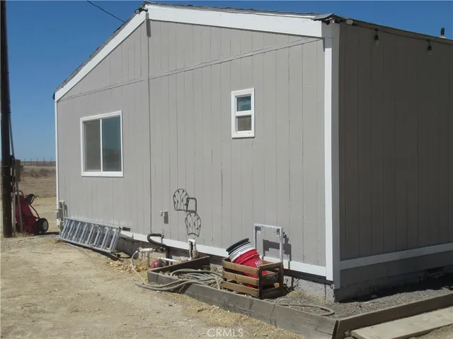 a view of a refrigerator in kitchen and a window