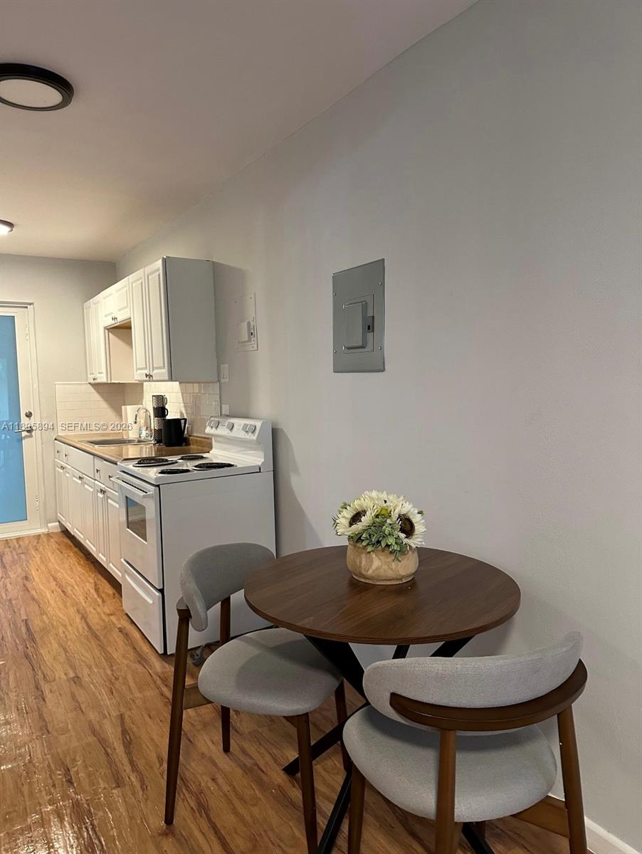 75 Washington Avenue, Unit 9 Miami Beach, FL 33139 - Photo 4 of 9 a view of a dining room with furniture and wooden floor