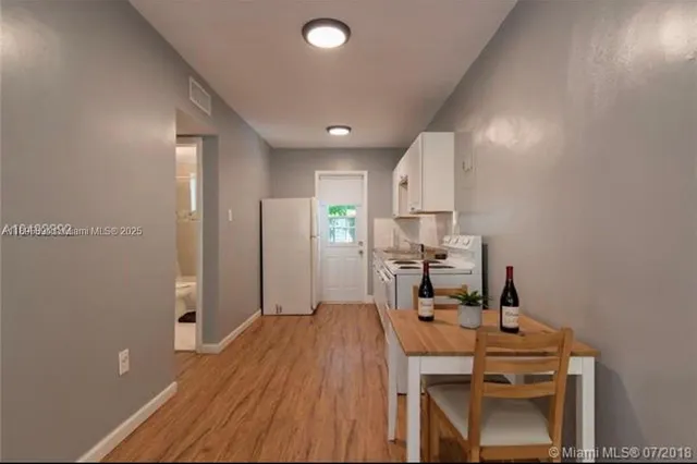 a view of a workspace with furniture and wooden floor
