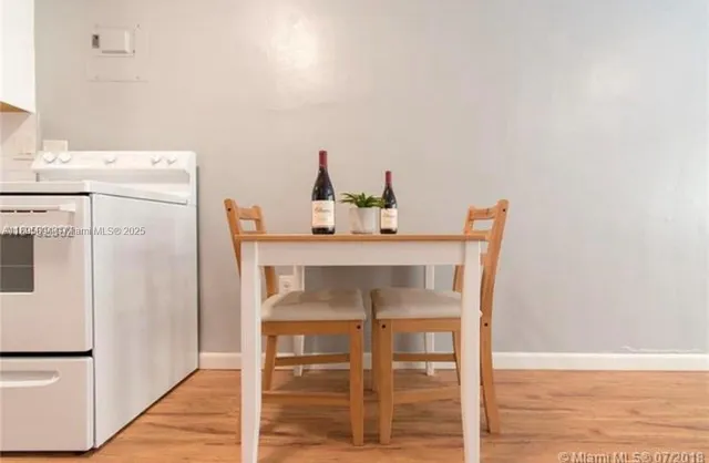 a dining room with furniture and wooden floor