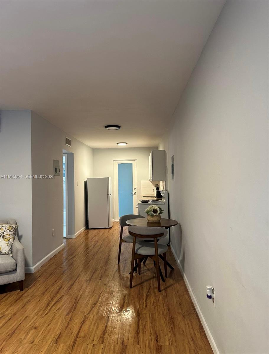 75 Washington Avenue, Unit 9 Miami Beach, FL 33139 - Photo 6 of 9 a living room with furniture and a wooden floor