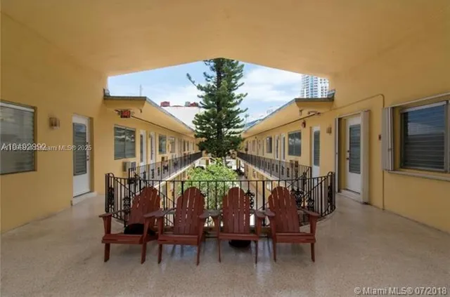 a view of a patio with table and chairs