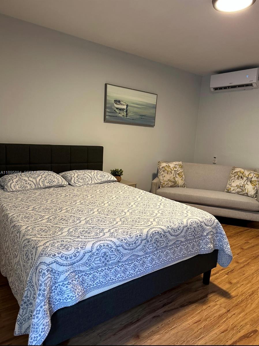 75 Washington Avenue, Unit 9 Miami Beach, FL 33139 - Photo 8 of 9 a bedroom with a bed and a couch