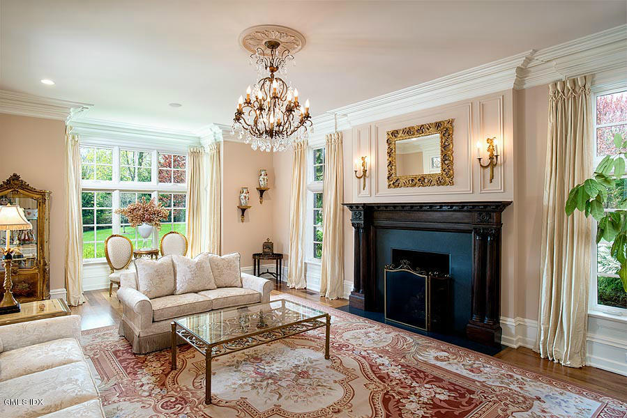 3 Jada Lane Greenwich, CT 06830 - Photo 9 of 26 a living room with furniture a chandelier and a fireplace