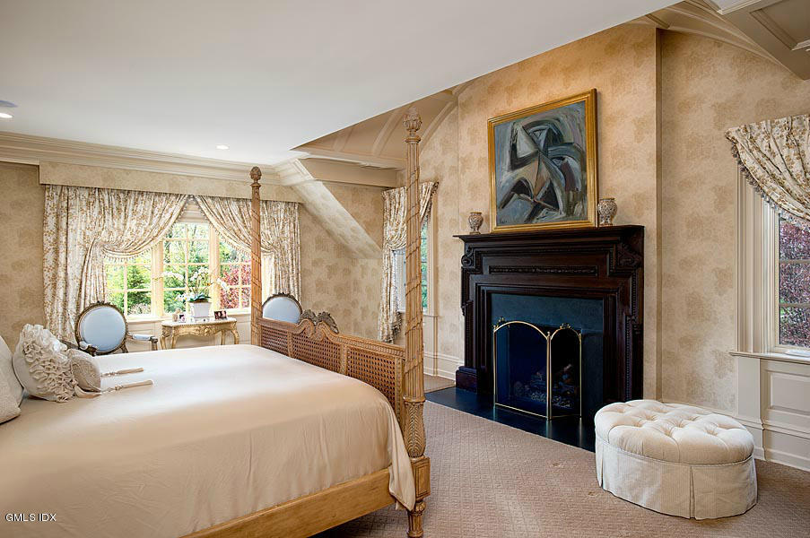3 Jada Lane Greenwich, CT 06830 - Photo 10 of 26 a bedroom with a bed and a painting on the wall