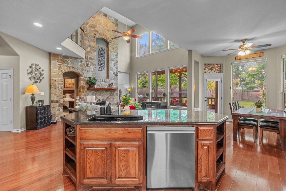 7505 Roaring Springs Drive Austin, TX 78736 - Photo 10 of 40 Kitchen featuring ceiling fan, open shelves, and stainless steel dishwasher