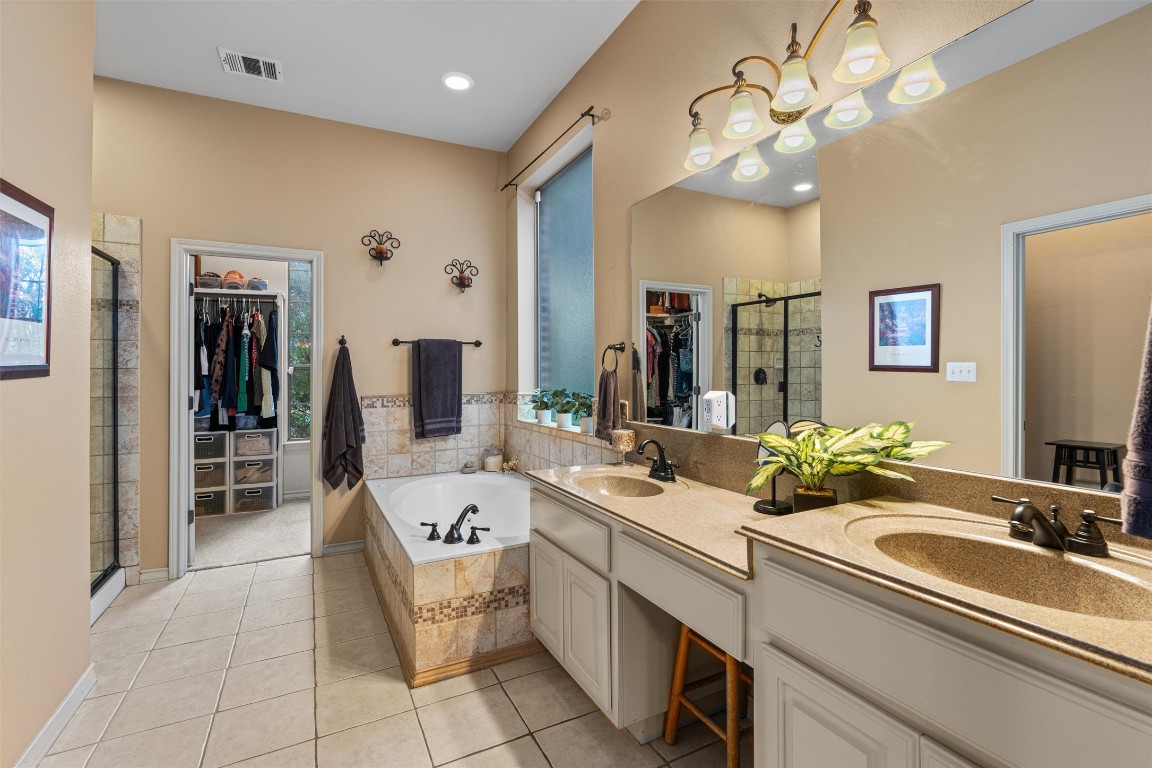 7505 Roaring Springs Drive Austin, TX 78736 - Photo 15 of 40 Primary Suite with Dual Vanities a Walk-in Shower and a Tub