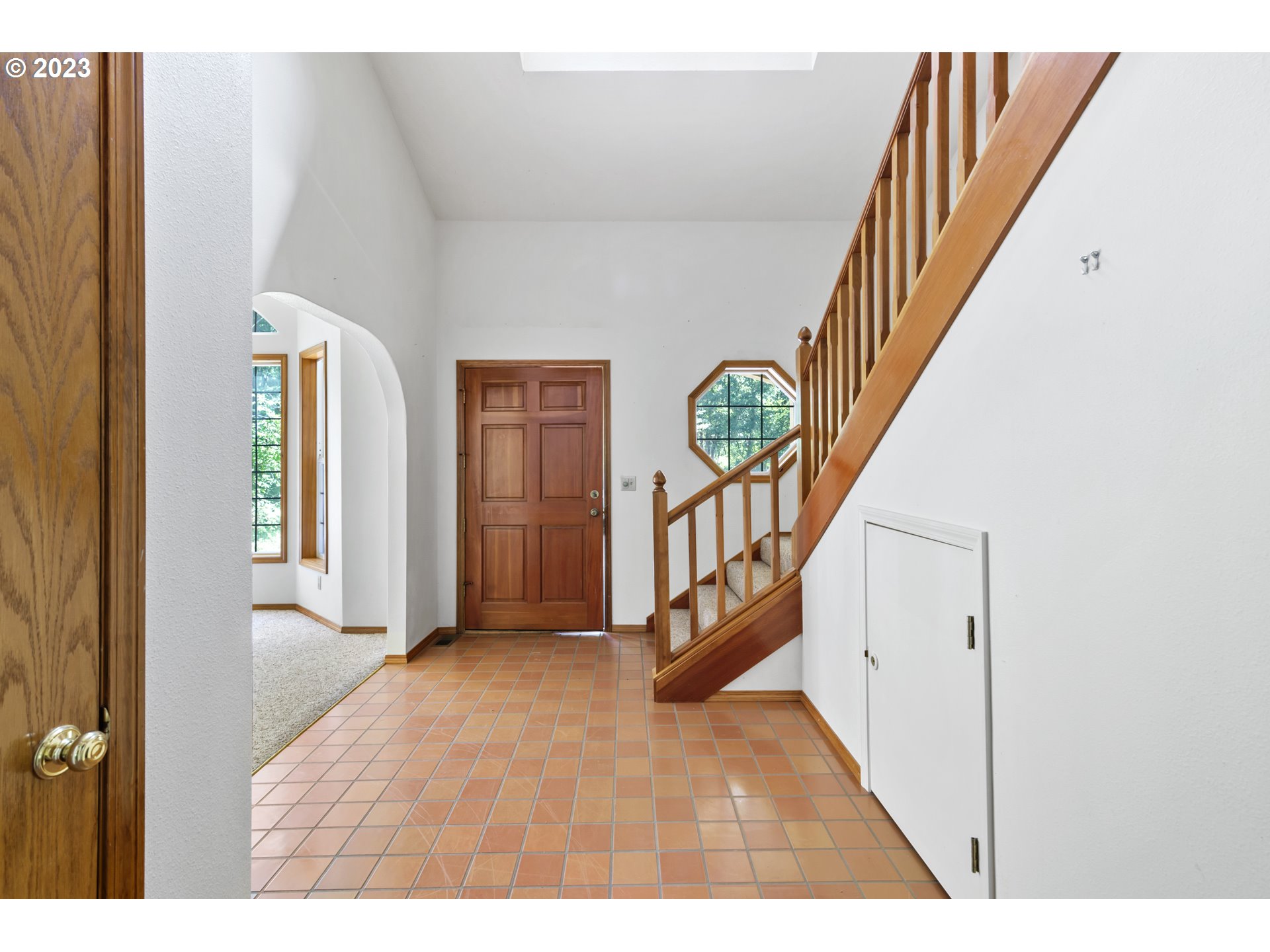 29510 Northwest 63rd Avenue Ridgefield, WA 98642 - Photo 4 of 38 a view interior of a house with wooden floor windows and a white door